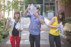3 kids tearing paper